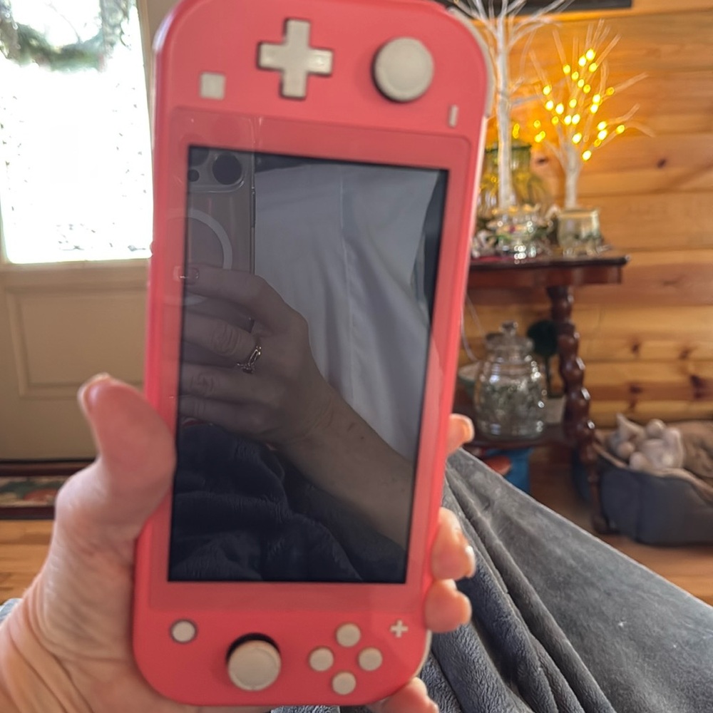 Like new orange/coral nintendo switch lite 32GB. Handheld.Excellent t condition.